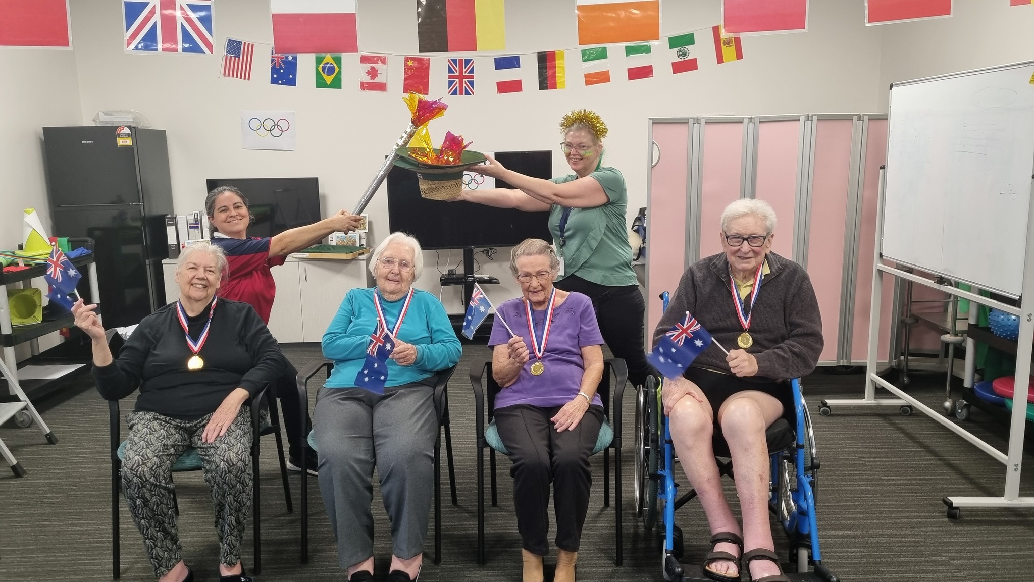 Residents and staff pose with their Olympic medals